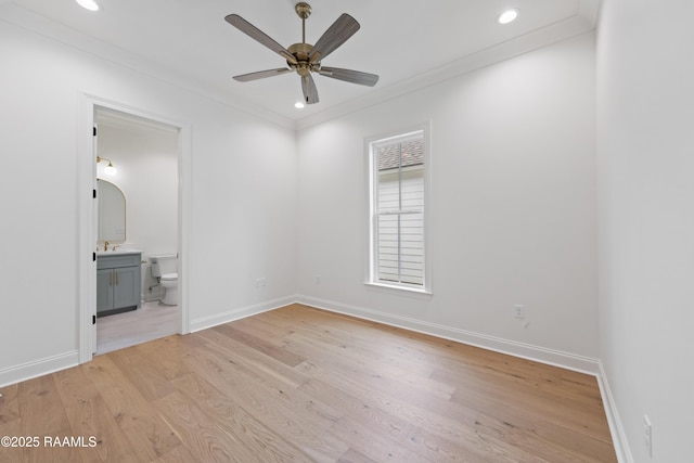 empty room with sink, crown molding, light hardwood / wood-style floors, and ceiling fan