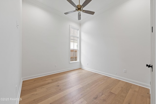 spare room featuring ornamental molding, light wood-type flooring, and ceiling fan