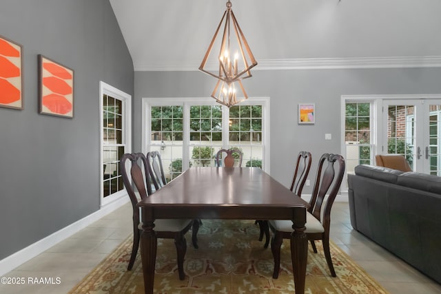 dining space featuring ornamental molding, light tile patterned flooring, vaulted ceiling, french doors, and a chandelier