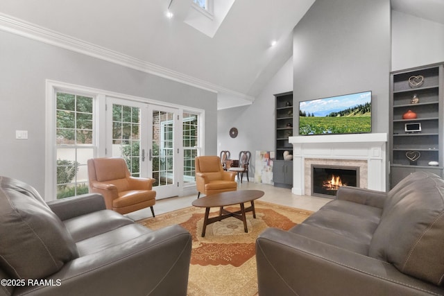 living room with built in features, high vaulted ceiling, ornamental molding, a premium fireplace, and french doors