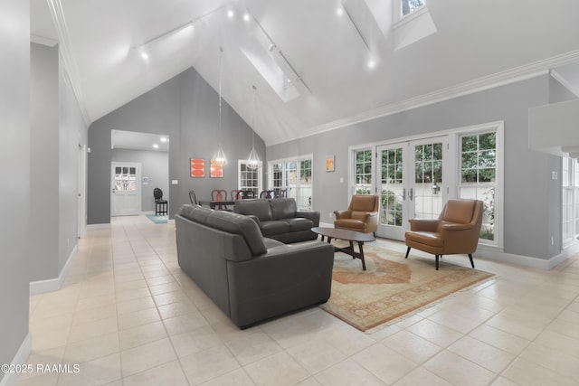 tiled living room featuring french doors, rail lighting, a skylight, high vaulted ceiling, and ornamental molding