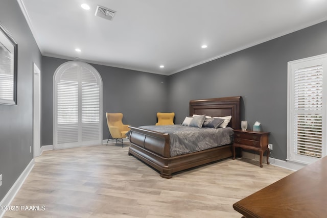 bedroom featuring crown molding and light hardwood / wood-style floors