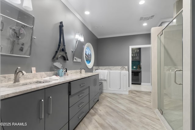 bathroom with vanity, crown molding, wood-type flooring, and a shower with door