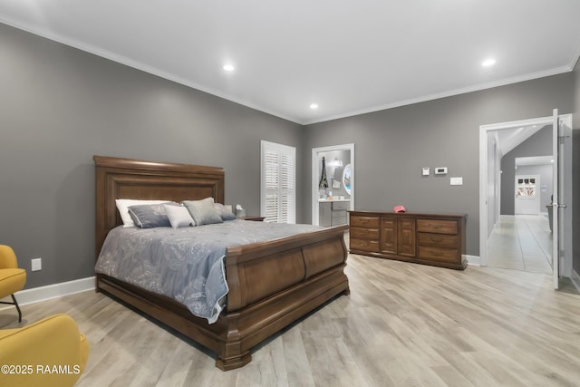 bedroom featuring ensuite bath, ornamental molding, and light hardwood / wood-style flooring