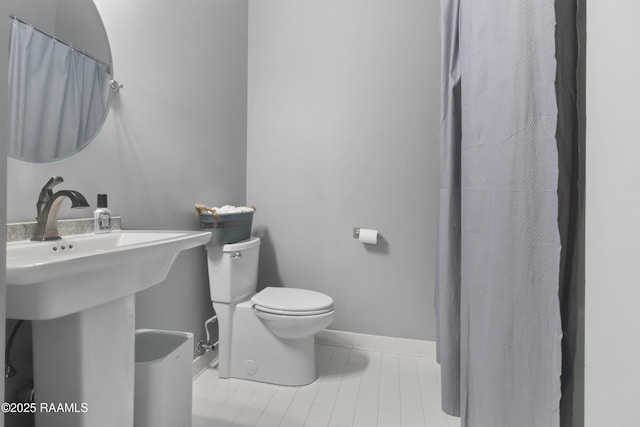 bathroom with tile patterned floors, toilet, and sink