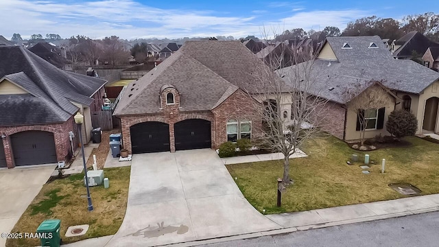 french country style house featuring a garage and a front lawn