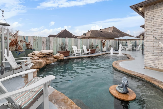 view of pool with a patio area and pool water feature