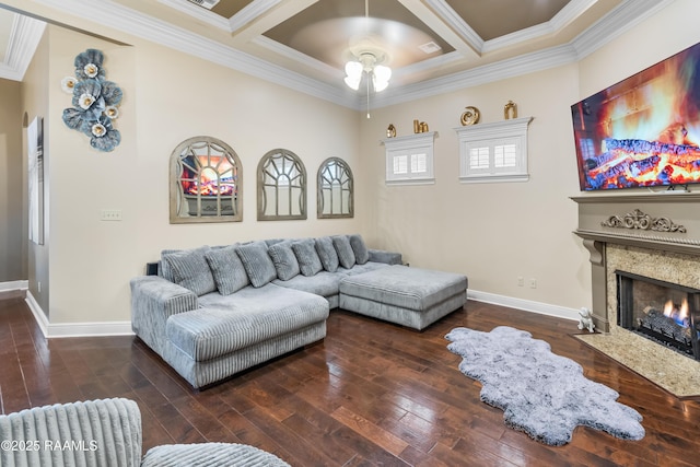 living room featuring coffered ceiling, ornamental molding, dark hardwood / wood-style floors, ceiling fan, and a fireplace