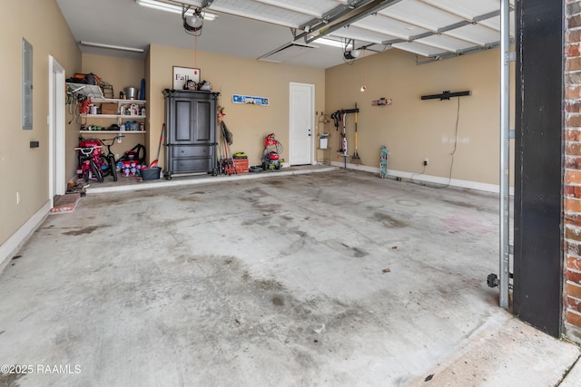 garage with a garage door opener and electric panel