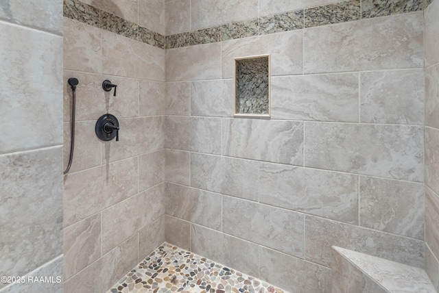 bathroom with a tile shower