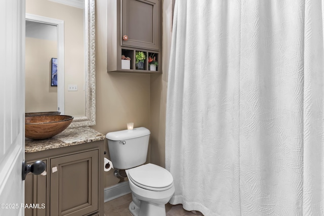 bathroom featuring crown molding, vanity, tile patterned floors, and toilet