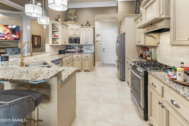 kitchen with appliances with stainless steel finishes, a breakfast bar, decorative light fixtures, sink, and kitchen peninsula