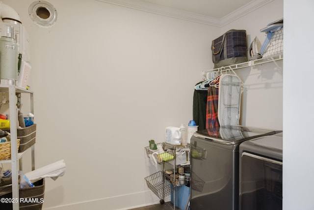 clothes washing area with ornamental molding and washer and clothes dryer