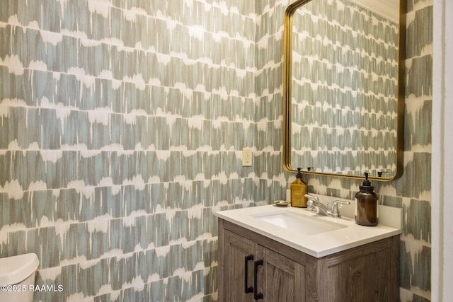 bathroom featuring vanity and toilet