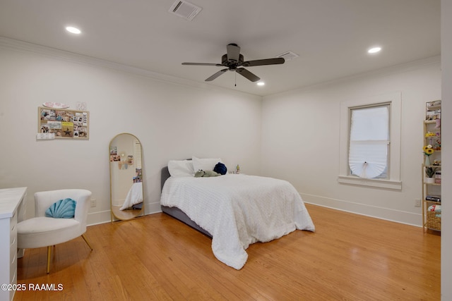 bedroom with wood-type flooring, crown molding, and ceiling fan