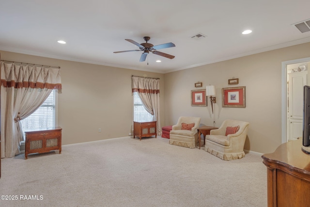 living area with light colored carpet, ornamental molding, and a wealth of natural light