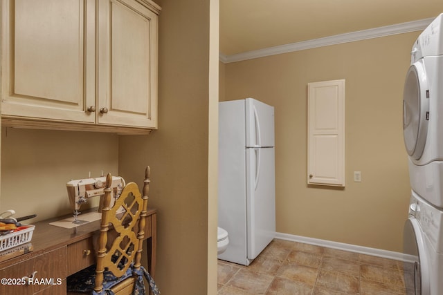 washroom featuring crown molding and stacked washer / dryer