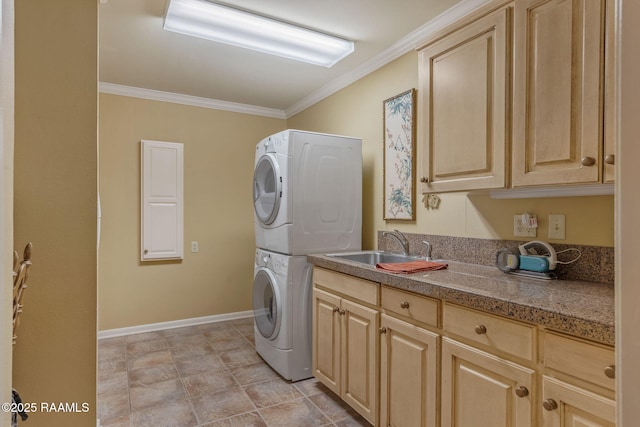 laundry room with cabinets, crown molding, stacked washer / drying machine, and sink