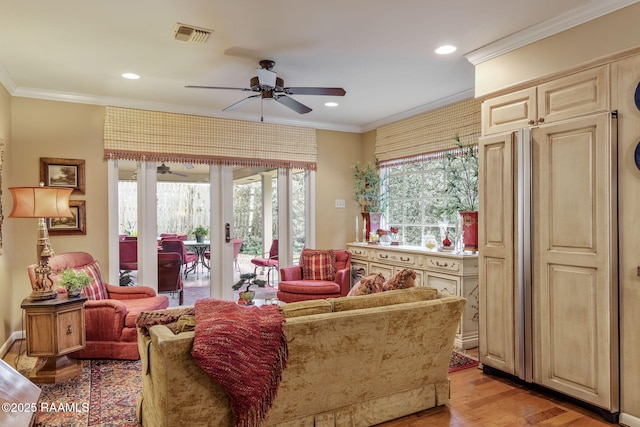 living room with crown molding, light hardwood / wood-style flooring, french doors, and ceiling fan