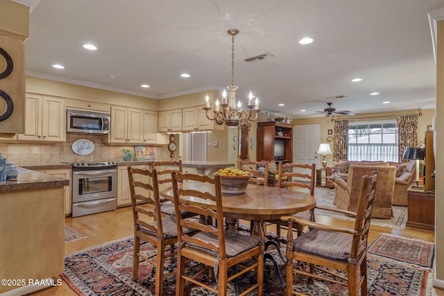 dining space featuring ceiling fan, ornamental molding, and light hardwood / wood-style floors