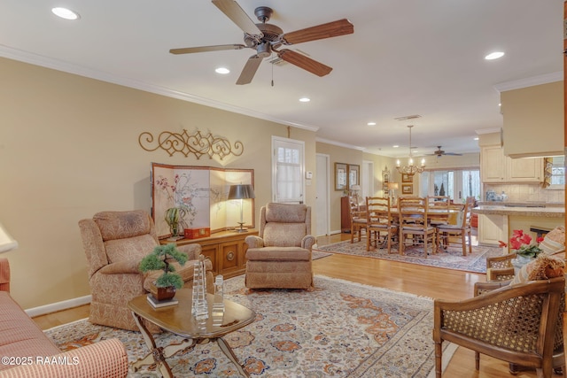 living room featuring crown molding, ceiling fan, and light wood-type flooring