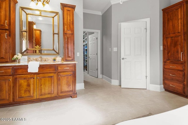 bathroom featuring ornamental molding and vanity