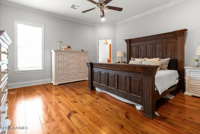 bedroom with wood-type flooring, ornamental molding, and ceiling fan