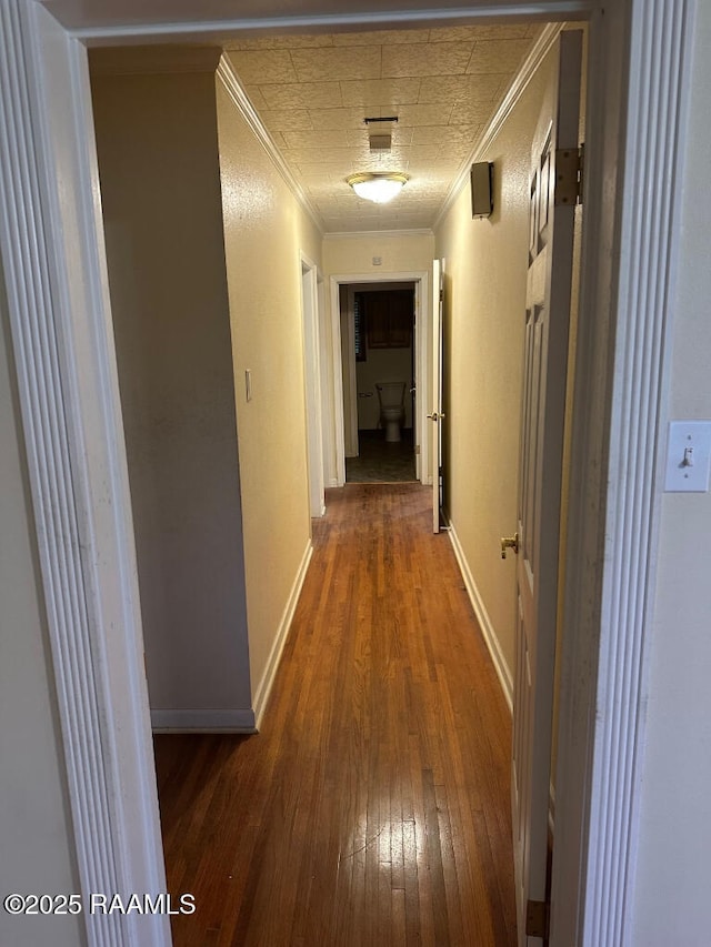 corridor featuring dark hardwood / wood-style flooring and ornamental molding