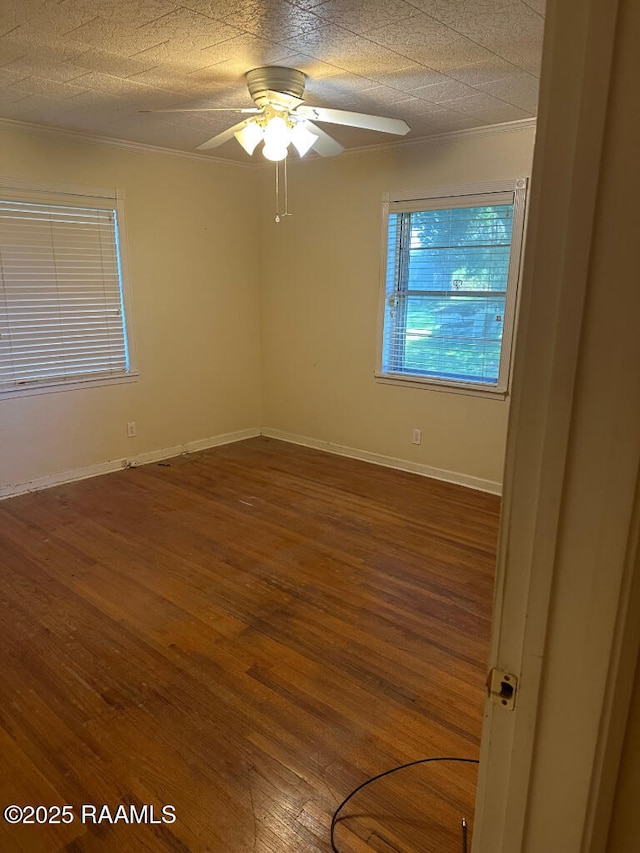 unfurnished room featuring wood-type flooring, ornamental molding, and ceiling fan