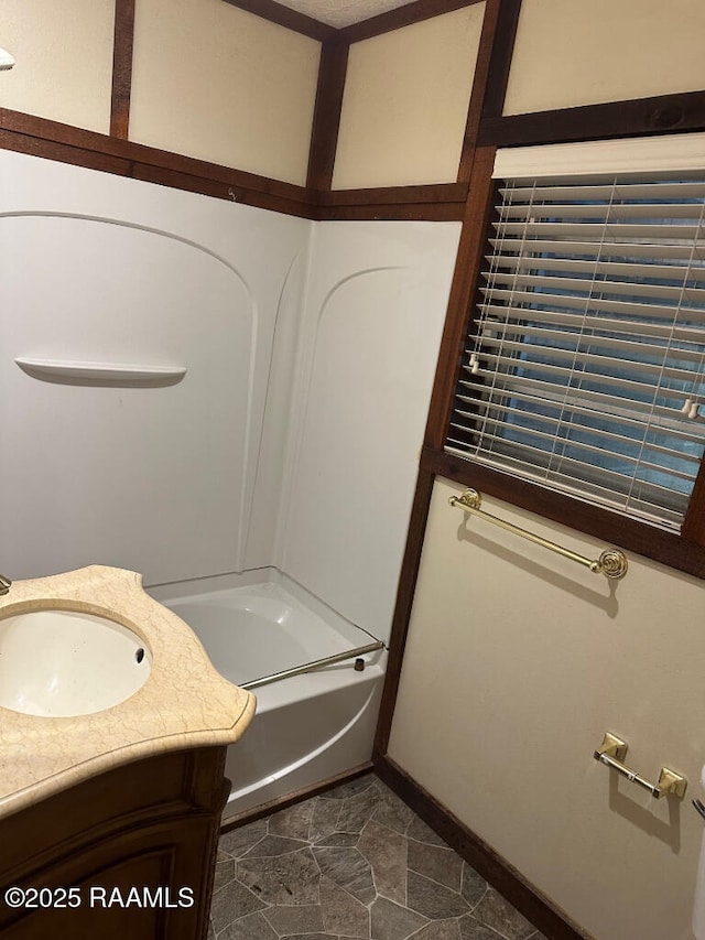 bathroom featuring vanity and a tub