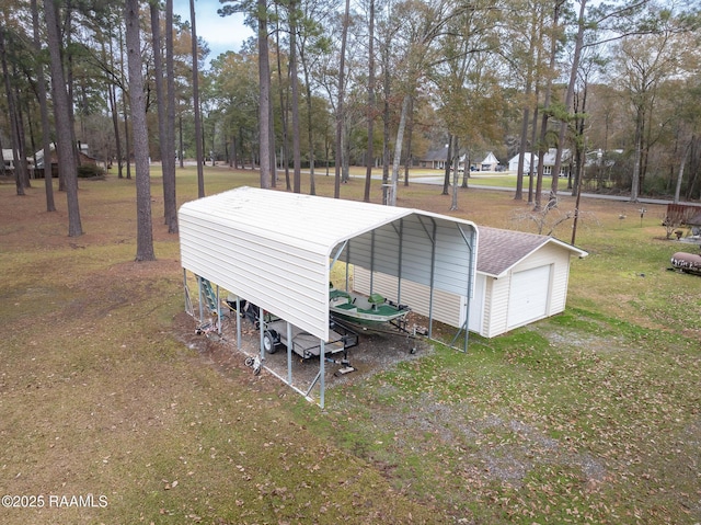 view of outbuilding featuring a carport, a garage, and a yard