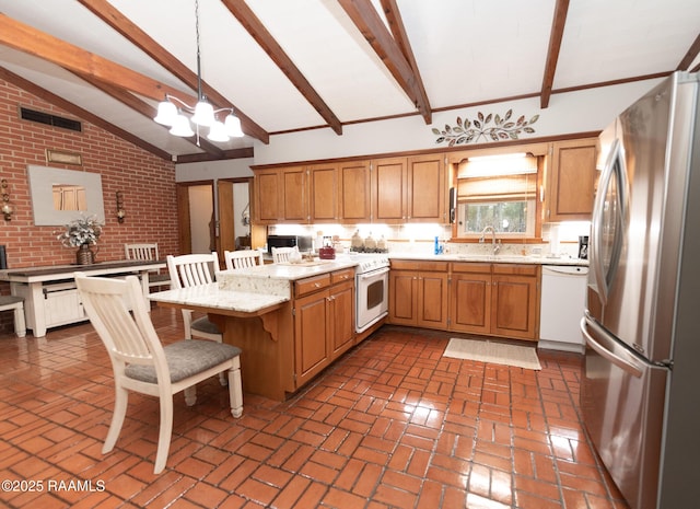 kitchen featuring sink, hanging light fixtures, beam ceiling, stainless steel appliances, and an inviting chandelier