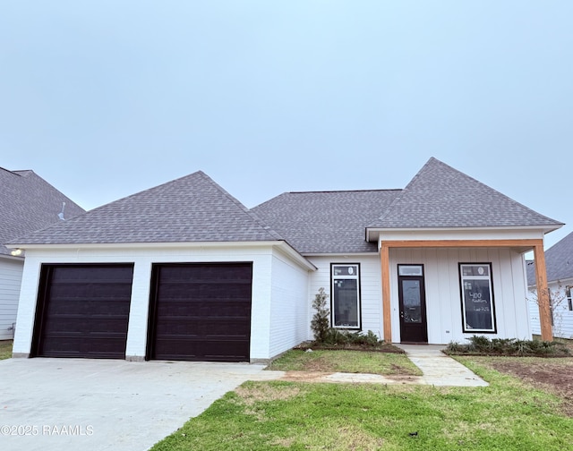 view of front of house with a garage and a front yard