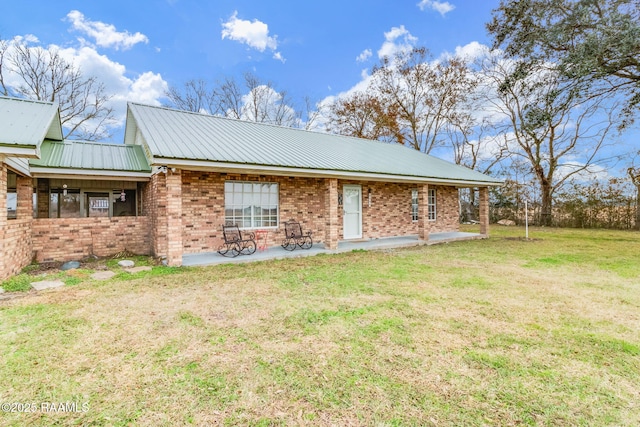 view of property exterior with a yard and a patio area