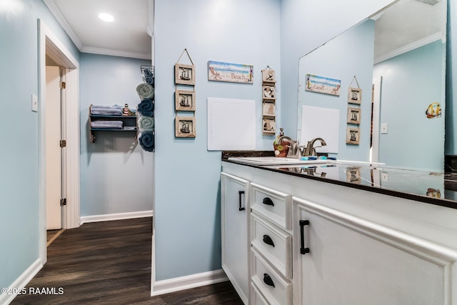 bathroom with vanity, wood-type flooring, and ornamental molding