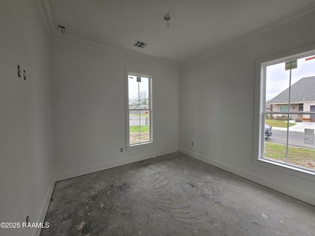 spare room featuring a healthy amount of sunlight, crown molding, visible vents, and baseboards