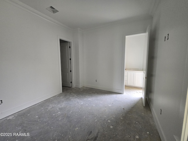 spare room with crown molding and baseboards