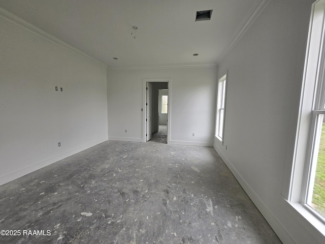 unfurnished room with plenty of natural light, baseboards, and crown molding