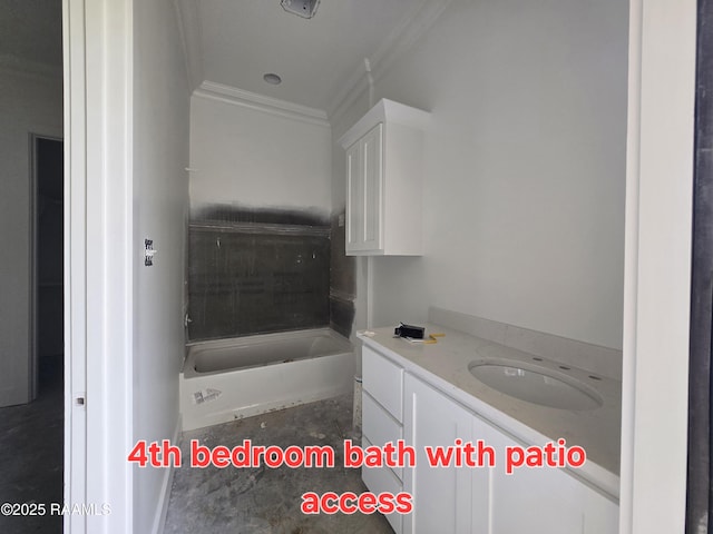 bathroom featuring ornamental molding, vanity, and a bathing tub