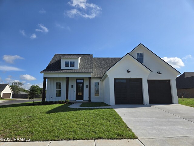 modern farmhouse style home featuring a front lawn, board and batten siding, roof with shingles, concrete driveway, and an attached garage