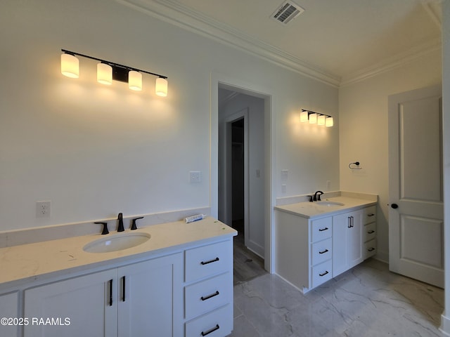 bathroom with visible vents, two vanities, crown molding, and a sink