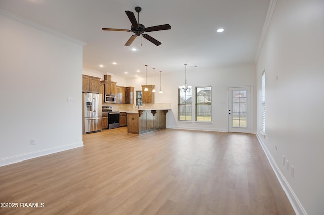 living room with ceiling fan with notable chandelier, ornamental molding, and light wood-type flooring