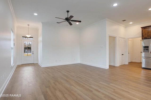 unfurnished living room with ornamental molding, light hardwood / wood-style floors, and ceiling fan