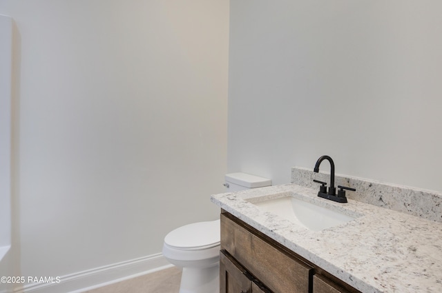 bathroom featuring vanity, tile patterned floors, and toilet