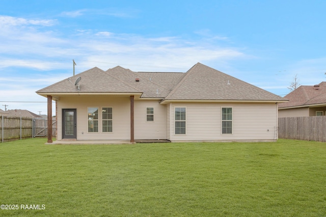 rear view of property featuring a patio area and a lawn