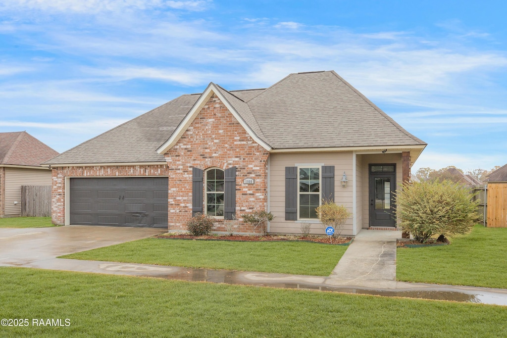 front of property with a garage and a front lawn
