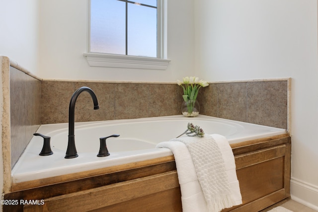 bathroom with a relaxing tiled tub