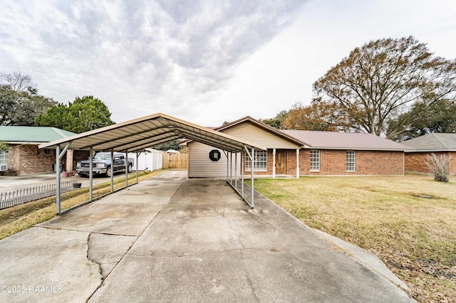 ranch-style house featuring a carport and a front lawn