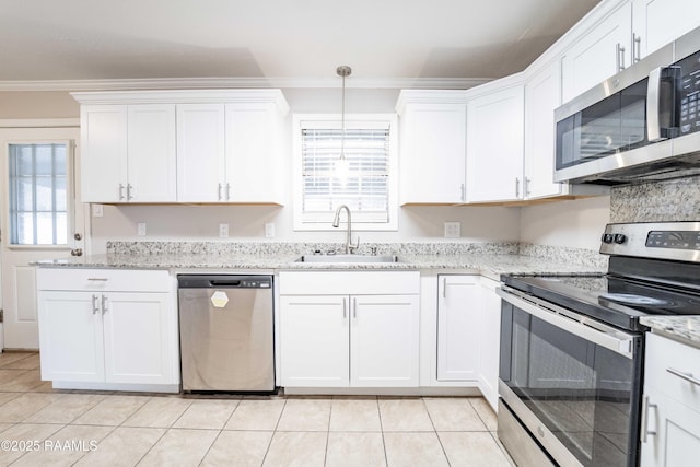 kitchen featuring decorative light fixtures, white cabinetry, sink, stainless steel appliances, and crown molding