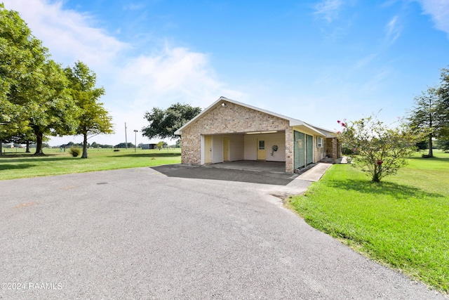 view of side of home with a carport and a yard